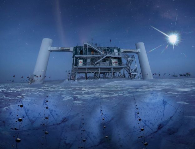 The IceCube facility, a structure built atop the ice in Antarctica. The picture is taken at nighttime, the moon a bright glow in the sky