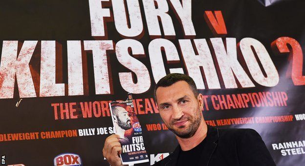 Wladimir Klitschko holds up a poster of Tyson Fury