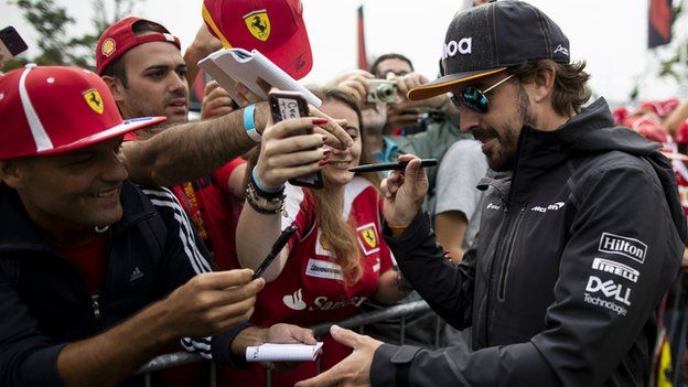 Fernando Alonso signs autographs for Ferrari fans at Monza in 2018