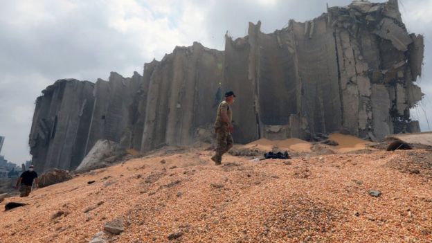 Lebanese army soldier walks on grain next to destroyed silos at Beirut's port (7 August 2020)