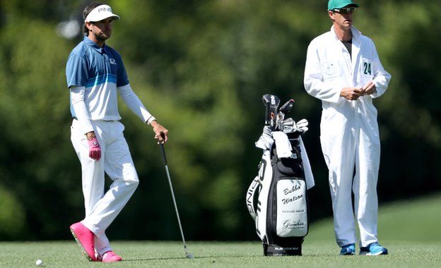 Bubba Watson wears pink high-top golf shoes during the 2018 Masters