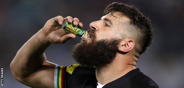 Australian rugby league player Josh Mansour drinks a shot of pickle juice during a game in Sydney in 2017