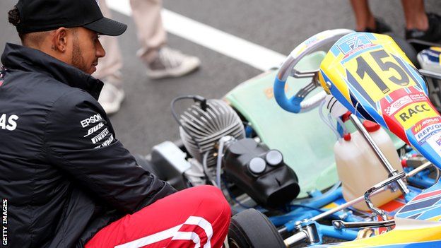 Lewis Hamilton inspects a kart on the track at Circuit de Barcelona-Catalunya