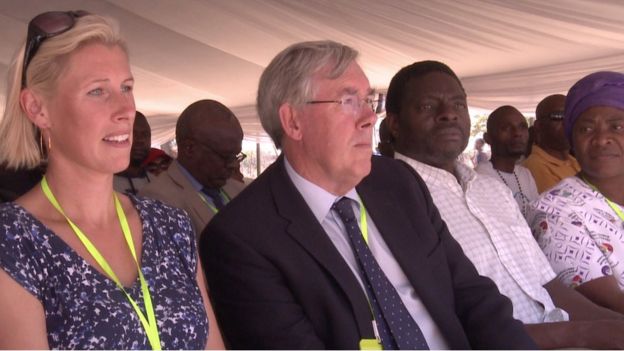 Attendees at the opening of the cause sit on chairs and watch proceedings.