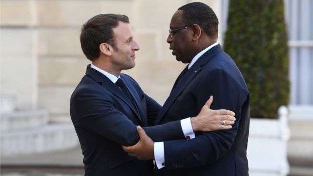 French President Emmanuel Macron (L) welcomes his Senegalese counterpart Macky Sall (R) before a meeting at the Elysee Palace in Paris on May 15, 2018