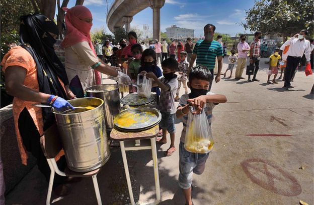 Street children being given food by a charity in Delhi during the coronavirus lockdown
