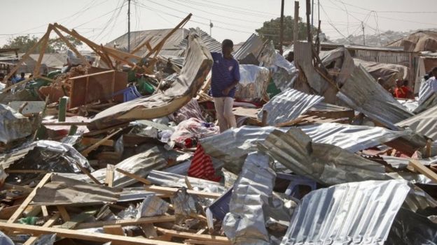 A shopkeeper surveys the wreckage of shops destroyed by the blast (19 February 2017)