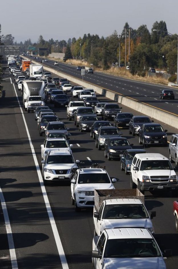 Vehicles travel south along Highway 101 as residents evacuate towns and cities in anticipation of the expected wind event on October 26, 2019 in Windsor, California