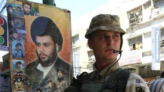 British soldier next to portrait of Moqtada al-Sadr in Basra, 2005