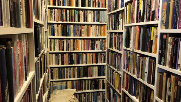 Shelves of Cutbill's LGBT+ book collection, which will be moved to the University of London.