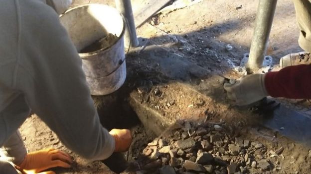 Renovators find objects hidden under a chimney at Auschwitz