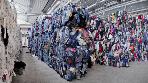 Piles of recycled garments pictured at I:CO