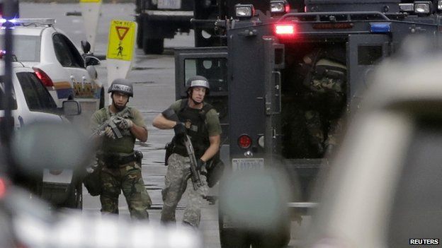 Law enforcement officers respond to a shooting at Washington Navy Yard on 16 September 2013