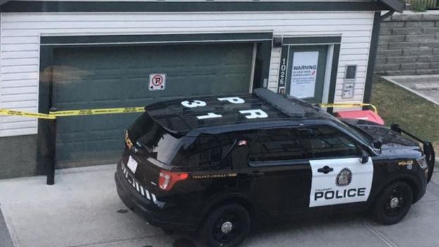 A police car is pictured outside a taped off property in Calgary
