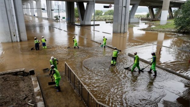 Workers under the Jamsu Bridge near the Han River in Seoul, South Korea, 04 August 2020