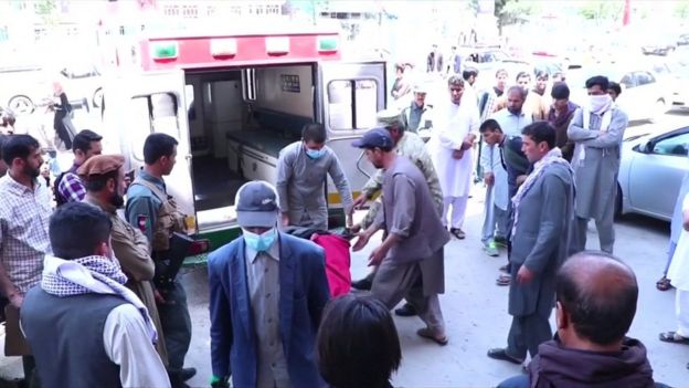 After the killing of journalist Mina Mangal, her body is transported in an ambulance