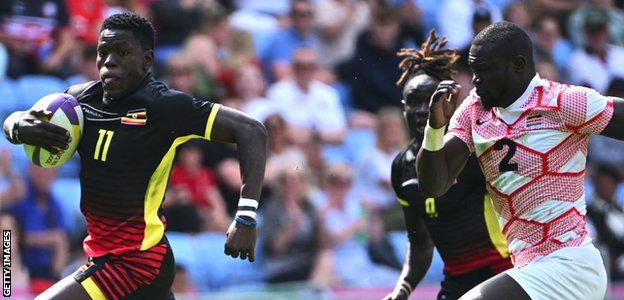 Uganda's Adrian Kasito runs with the ball during their Pool D rugby sevens match against Kenya