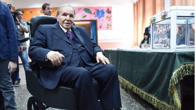 Algerian President Abdelaziz Bouteflika is seen on a wheelchair as he casts his vote at a polling station in Algiers during parliamentary elections, 4 May 2017.