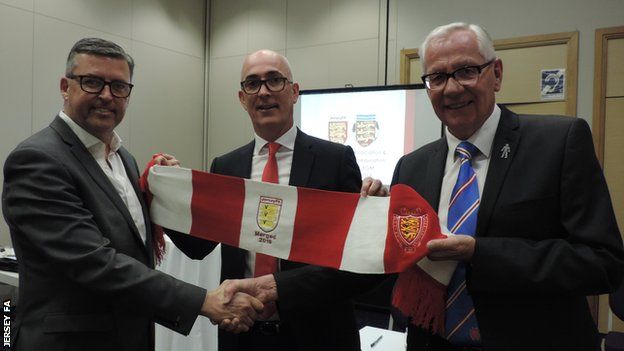 Jersey FA vice-president Bradley Vowden (left), JFA chief executive Jean-Luc Desbois (centre) and Jersey Football Combination president Charlie Browne celebrate the merger