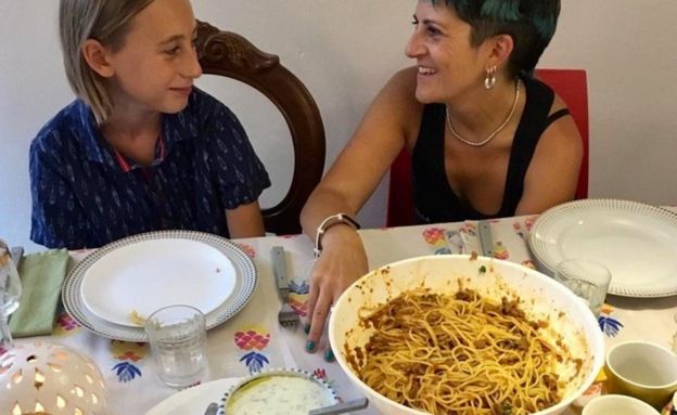 Italians at a table where "suugo suqaar"and "baasto" is being served in Palermo, Sicily - Italy, 2019