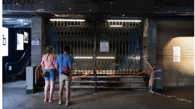 Two people outside a closed Admiralty station, Hong Kong, 5 October 2019