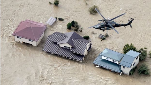Defence force helicopter flying over residential areas flooded by the Chikuma river following Typhoon Hagibis in Nagano, central Japan, October 13, 2019