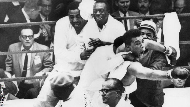 Muhammad Ali, then known as Cassius Clay, celebrates after beating Sonny Liston in Miami in 1964