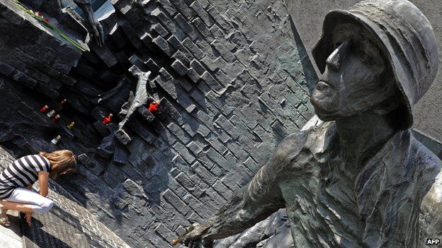 Woman at a Warsaw monument commemorating the Polish who fought German occupation troops during the Warsaw Uprising in World War II