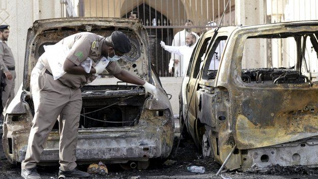 Policeman carries out an inspection after a car exploded near a Shia mosque in Saudi Arabia"s Dammam