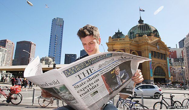 Newspaper reader in Melbourne, Australia