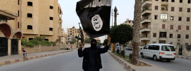 Islamic State militant waving flag in Raqqa
