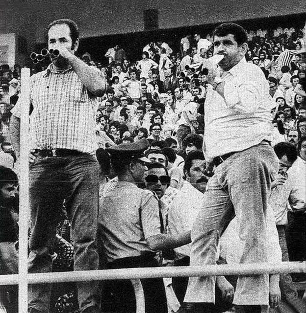ممد بوقی و حسن تارزان دو بوقچی سرشناس پرسپولیس و تاج که اینجا به اتفاق هم برای تیم ملی بوق میزنند. حضور پرتعداد زنان هم در عکس مشهود است