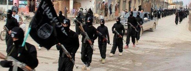 Fighters from Islamic State march through Raqqa, Syria, from an undated image