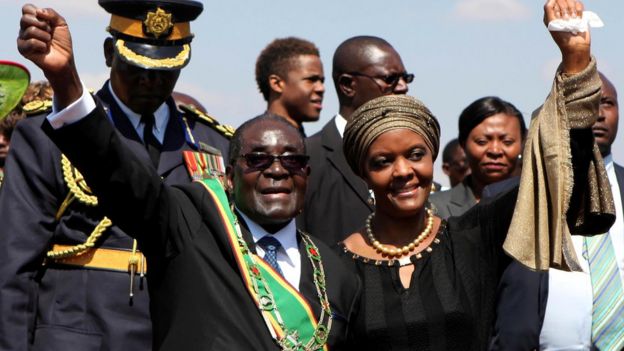 Zimbabwe President Robert Mugabe (L) and his wife Grace (R) greet supporters at a national Heroes Day rally in Harare, August 11, 2014