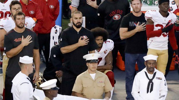 Colin Kaepernick kneels during the national anthem before a pre-season game