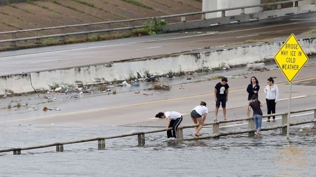 People view the flooded highways in Houston (27 August 2017)