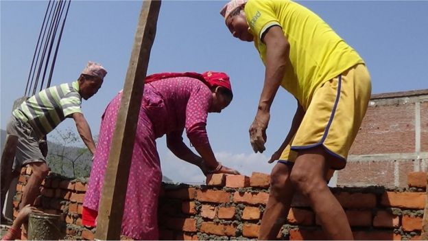 Sanumaya Kumal and men working at the building site at Bidur in Nuwakot district