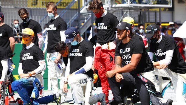 Drivers take the knee and stand during the Austrian Grand Prix