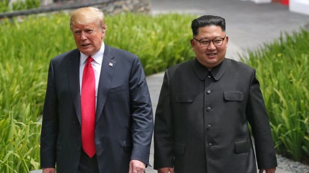 US President Donald Trump walks with North Korean leader Kim Jong Un at the Capella Hotel on Sentosa island in Singapore on 12 June 2018
