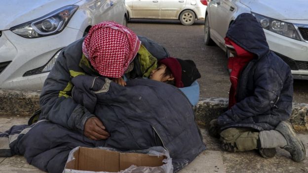 A Syrian man begs for money for his family on a roadside in Manbij, northern Syria (31 December 2018)