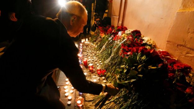 Russian president Vladimir Putin puts flowers down outside Tekhnologicheskiy Institut metro station in St. Petersburg, Russia, April 3, 2017