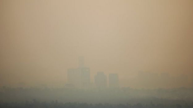 Buildings are seen through the air pollution during a day where Mexico City's authorities have activated a contingency plan due to bad air conditions on May 14, 2019 in Mexico City