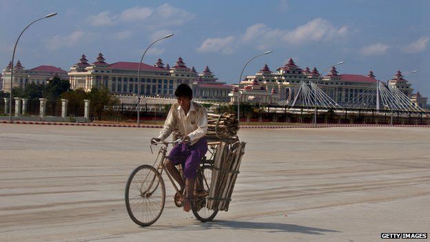 Cyclist in front of the Myanmarese parliament building in the capital Naypyidaw