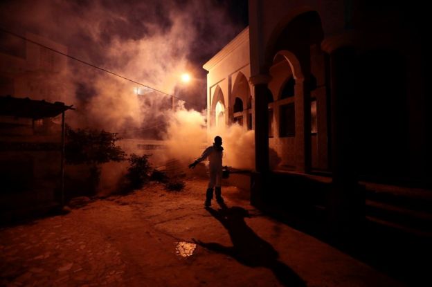 A member of local hygiene services wears a protective suit and face masks, disinfects a mosque to stop the spread of coronavirus disease (COVID-19), in Dakar, Senegal April 1,