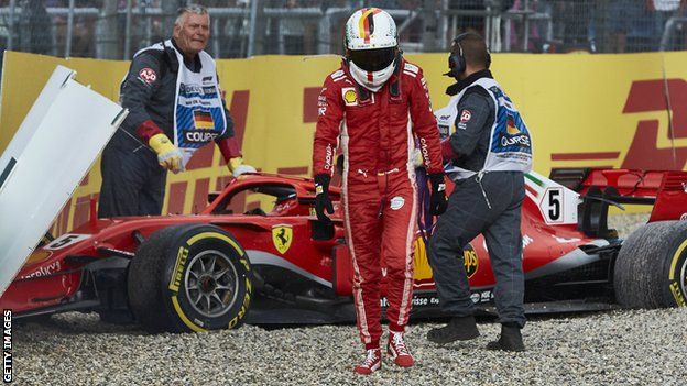 Sebastian Vettel walks away after crashing his Ferrari while leading the German Grand Prix in 2018