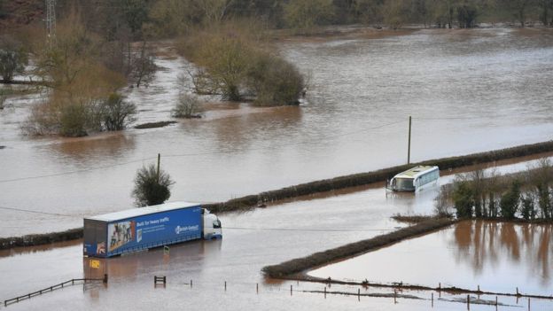 A lorry and a coach submerged in floodwater from the River Teme on the A443 near Lindridge, Worcestershire, as the aftermath of Storm Dennis brings heavy rain and flooding