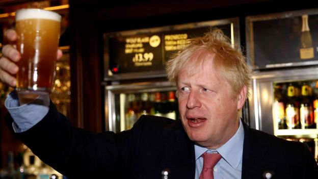 Boris Johnson holding a pint