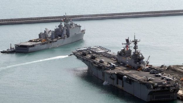 The amphibious assault vessel USS Bonhomme Richard (right) and the USS Ashland leave the south-eastern port of Busan, South Korea (07 March 2016)