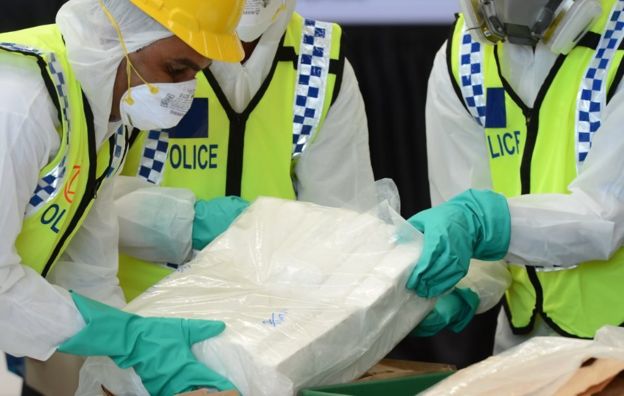 Sri Lankan police personnel prepare seized cocaine to be destroyed under judicial supervision in Katunayake on January 15, 2018. Around a tonne of the narcotics has been seized over the past year while in transit via Colombo