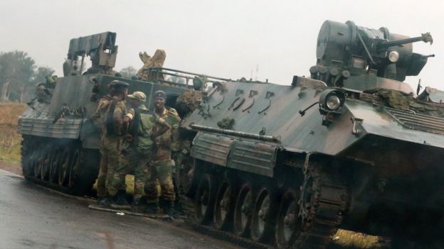 Soldiers stand beside military vehicles just outside Harare, Zimbabwe, 14 November 2017